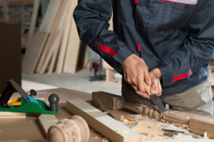 Carpenter using wood tools